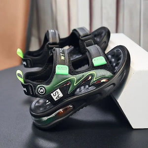 Black and green sandals with visible branding on a dark surface.