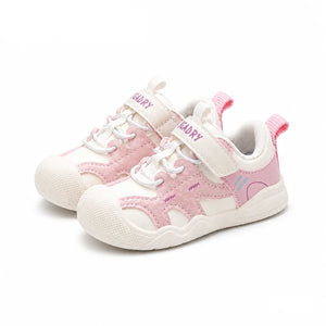 A pair of children's sneakers in pink and white, featuring hook-and-loop straps, lace-up front, and textured rubber soles, shown on a white background with 'PmwRun' branding and 'Pink' text.