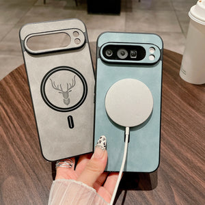 Two Leather Magnetic Cases for Pixel with a deer emblem and wireless charging pad on a wooden surface.