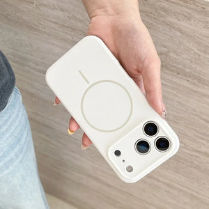 Hand holding a white phone case with a brand logo on a wooden surface