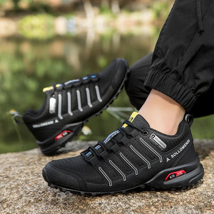 Black hiking shoes with visible brand name on a blurred natural background