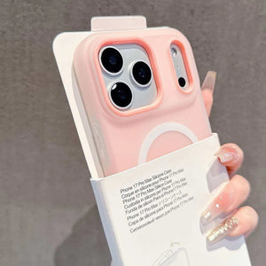 Pink phone case held by a hand with a gray background