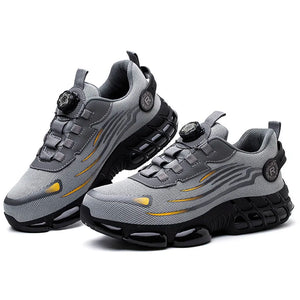Gray and black athletic work shoes with yellow accents on a white background