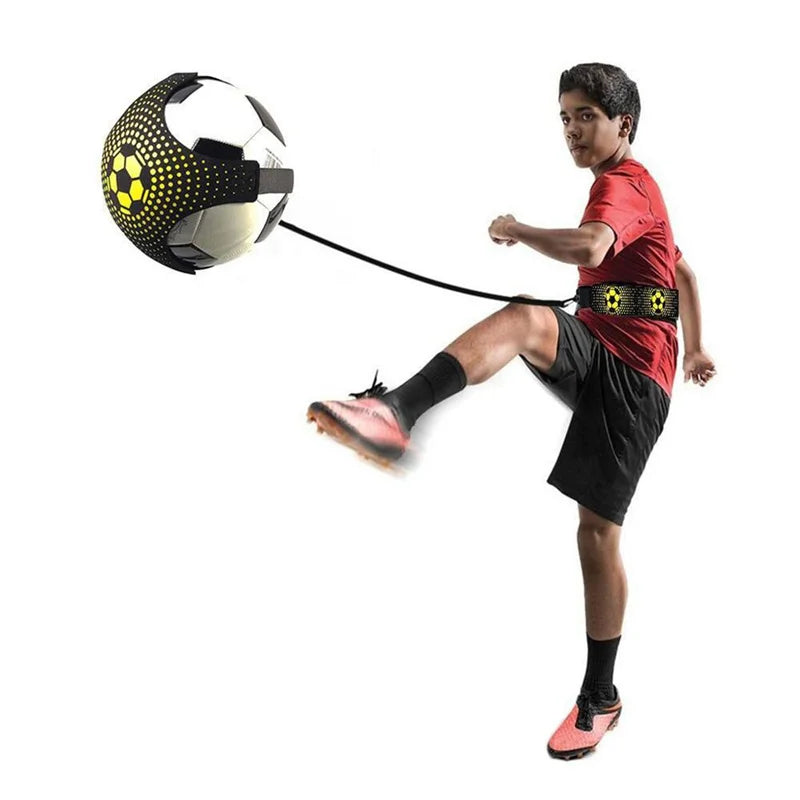 Person kicking a soccer ball with a strap attached on a white background