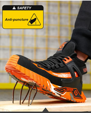 Black and orange safety shoe with anti-puncture feature on a wooden surface.