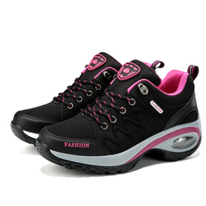Black and pink fashion sneakers on a white background