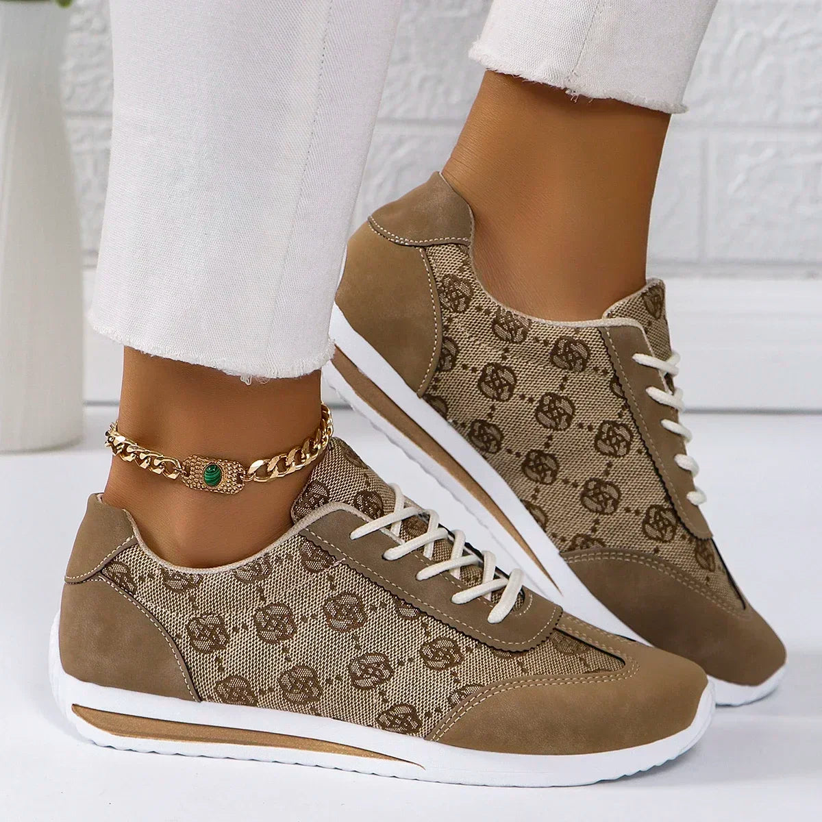 Brown patterned sneakers with white soles worn by a person on a white background