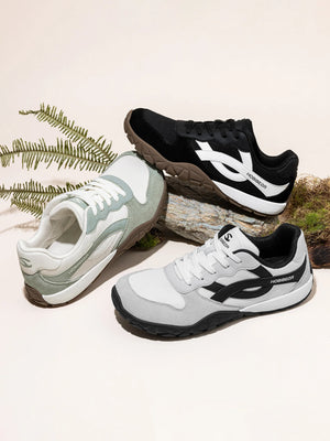 Three pairs of shoes in different colors on a light background with natural elements.