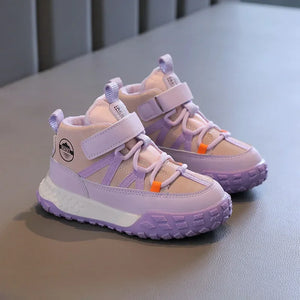 A pair of children's mid-top sneakers in pastel lavender and beige, featuring hook-and-loop straps, lace-up detailing, and a chunky white and lavender sole, displayed on a gray surface.