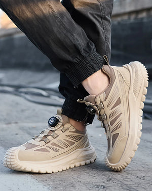 Beige tactical safety work shoes worn by a person on a concrete surface