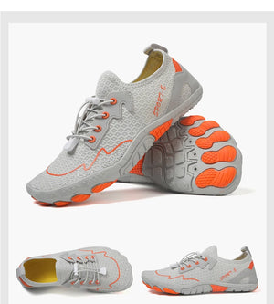 Gray and orange athletic shoes on a white background