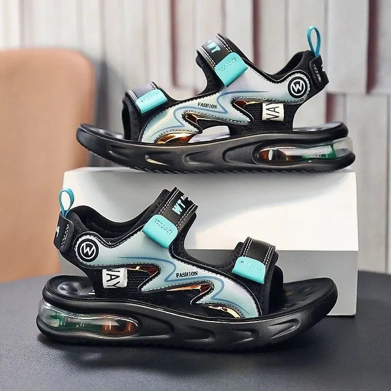 Black and turquoise sandals with air cushion sole on a gray surface.