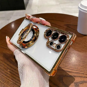 Luxury Clear Samsung Galaxy case with electroplated frame and magnetic ring stand with gold accents held by a person.