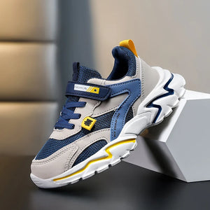 Children's sneaker with blue and gray design on a neutral background