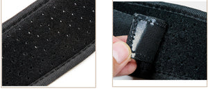 Close-up of a black fabric patch with a textured surface and a label on a white background.