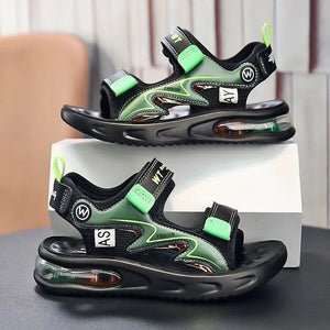 Black and green sandals with air cushion sole on a gray surface