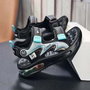 Black and blue children's sandals with visible branding on a dark surface.