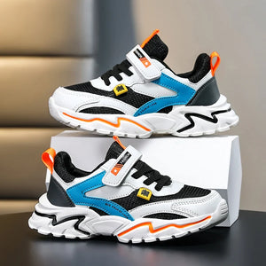 Pair of children's sneakers with black, white, blue, and orange design on a neutral background