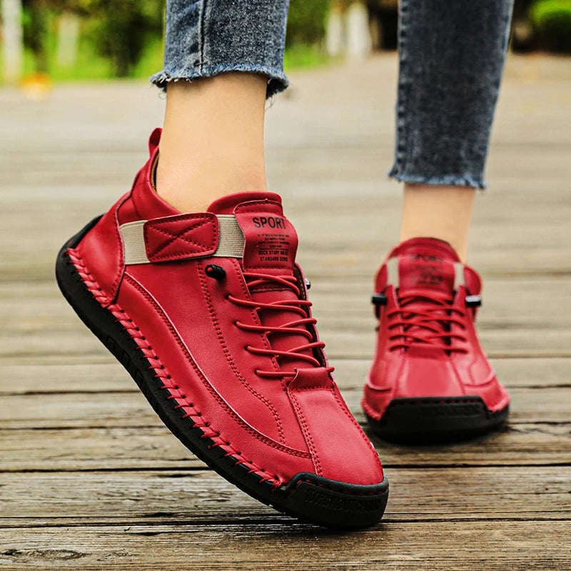 Red Slip-On Shoes with black soles on a wooden floor