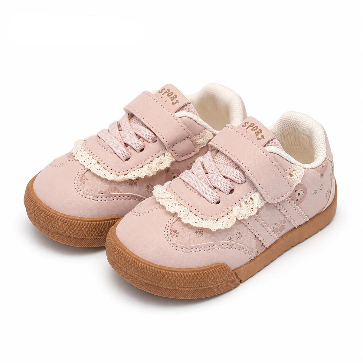 A pair of PmwRun toddler sneakers in a light pink color, featuring lace-up front, hook-and-loop straps, delicate lace trim, and brown rubber soles, shown on a white background
