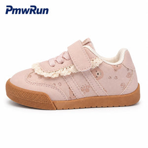 A pink children's sneaker by PmwRun, featuring a hook-and-loop strap, a decorative cream lace trim, paw print details, and a brown gum sole, shown on a white background.