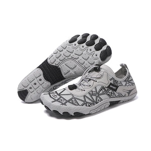 Pair of gray athletic shoes with black pattern on a white background