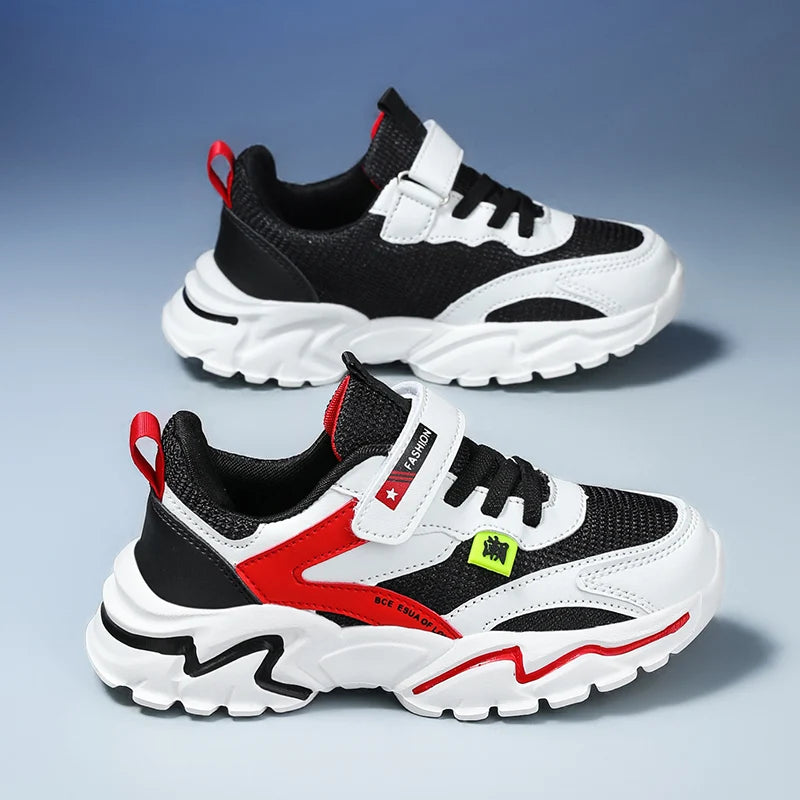 Black, white, and red children's sneakers on a gradient blue background