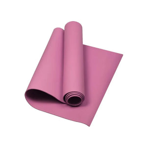 Pink yoga mat rolled up on a white background
