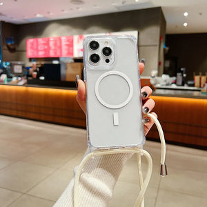 Person holding a phone with a clear case featuring a magnetic charging pad in a blurred indoor setting.