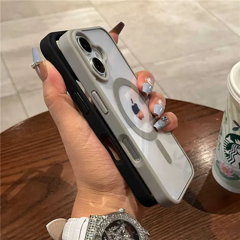 Hand holding a iphone with a case featuring a cartoon character, on a wooden surface with a Starbucks cup in the background.