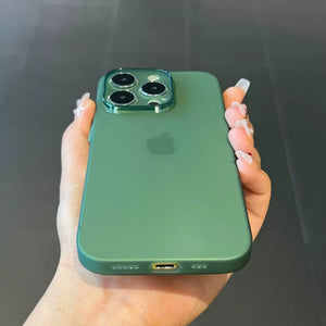 Green smartphone held in a hand against a dark background