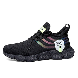 Black sneaker with colorful sole and brand tag on a white background