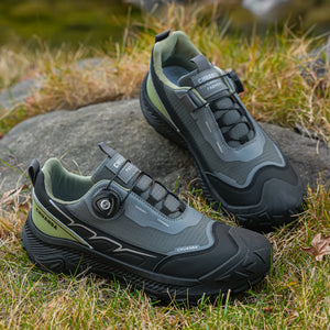 Pair of black and gray hiking shoes on a natural background