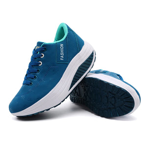 Blue sneakers with white soles on a white background