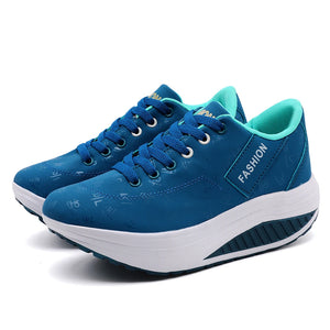 Blue platform sneakers with white soles on a white background