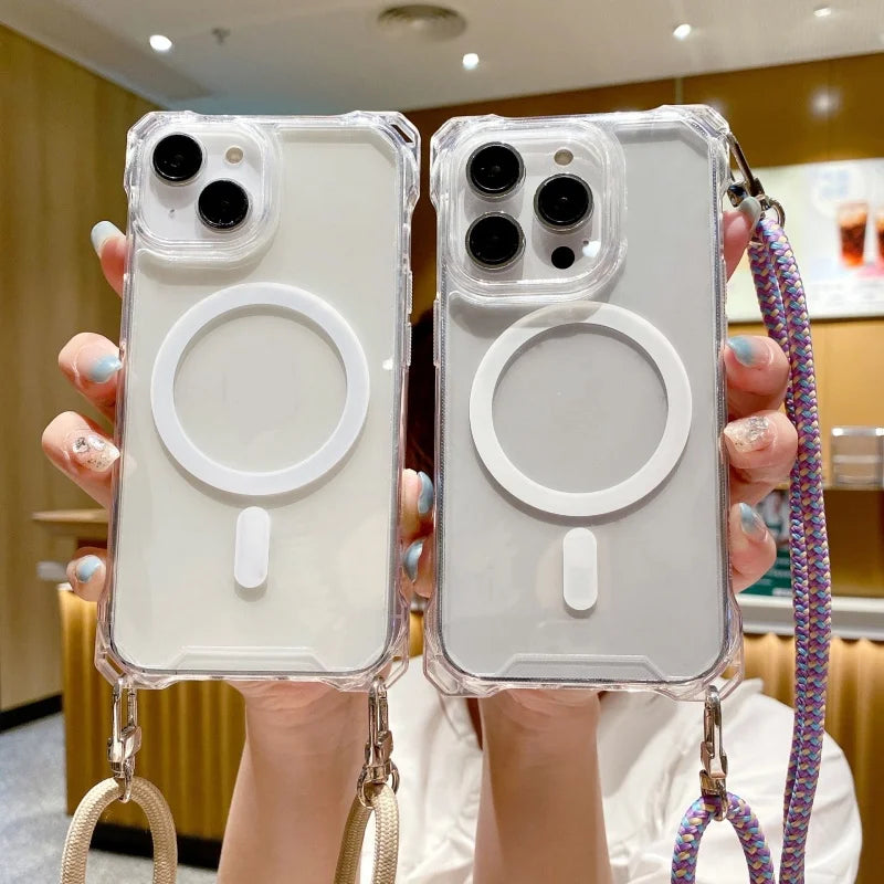 Two clear iphone cases with MagSafe rings held by a person in an indoor setting.