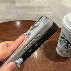 Person holding a iphone case next to a Starbucks cup on a wooden table.