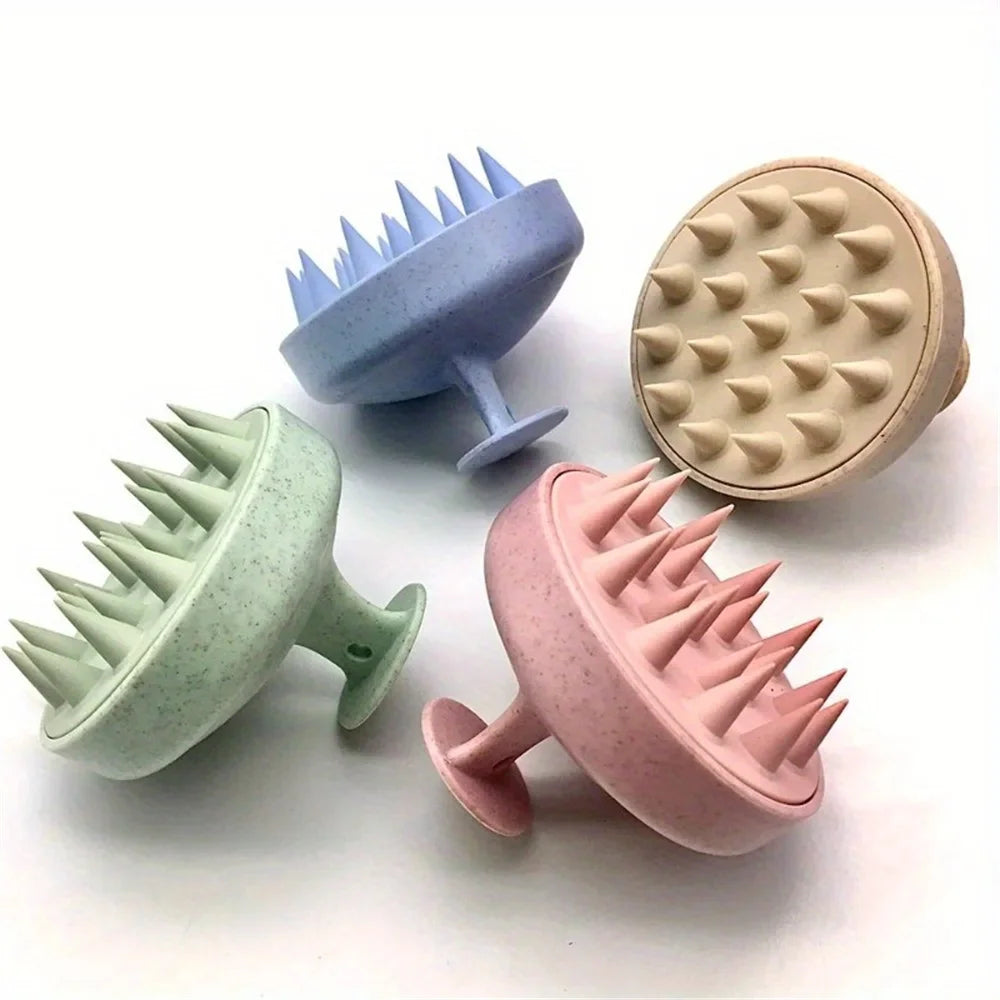 Four textured scalp massage brush in pastel colors on a white background