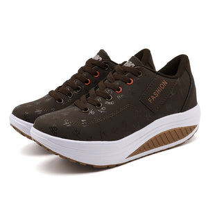 Brown fashion sneakers with white soles on a white background