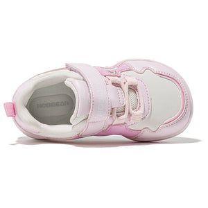A light pink and white toddler sneaker with hook-and-loop strap closures, shown from a side profile view on a white background.