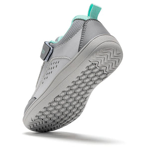 A light gray slip-on shoe with a hook-and-loop strap closure and a mint green pull tab, shown from a three-quarters angle on a white background.