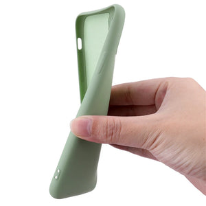 Hand holding a light green phone case on a white background