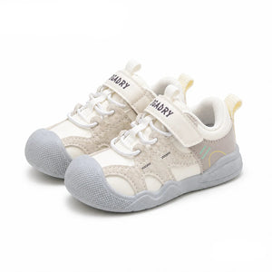 A pair of toddler sneakers in beige and light gray, featuring hook-and-loop straps and textured rubber soles, shown on a white background with 'PmwRun' and 'Beige' text overlays.