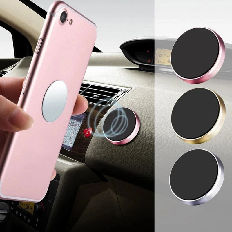 Pink phone holder with car mount and additional holders on a car dashboard.