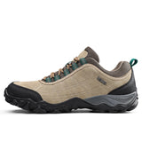 Beige and brown hiking shoe with black sole on a white background