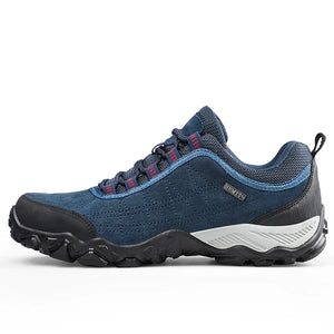 Blue hiking shoe with black sole on a white background