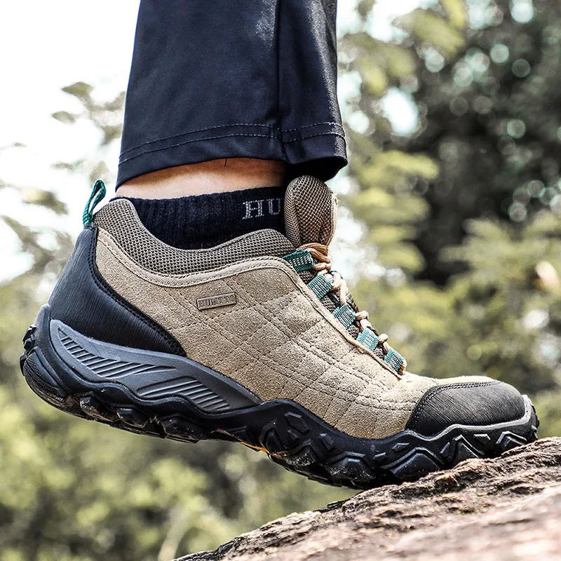 Hiking boot on a rock with a blurred natural background