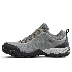 Gray hiking shoe with black sole on a white background
