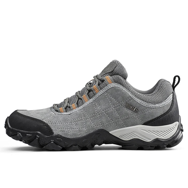 Gray hiking shoe with black sole on a white background