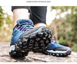 Close-up of blue hiking shoes with black soles on a blurred natural background